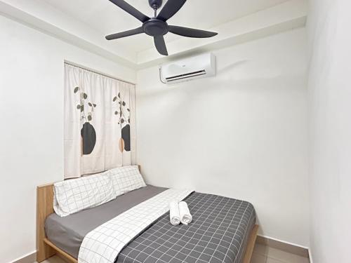 a bedroom with a bed with a ceiling fan at Kulai d putra suites beside ioiMall near JPO and Airport in Kulai