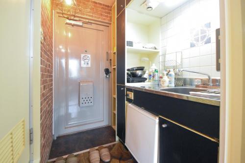 a small kitchen with a sink and a counter at Comfy Stay Sakuramachi in Nara