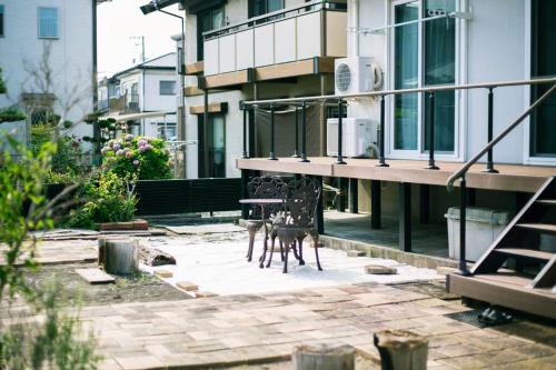 a patio with a table in front of a building at Roopt陸前赤井 in Higashimatsushima