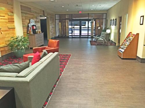 a lobby with a couch and chairs in a building at Wyndham Garden Inn Pittsburgh Airport in Robinson Township