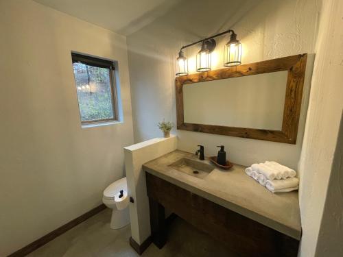 a bathroom with a sink and a mirror at The Rocky Retreat in Cookson