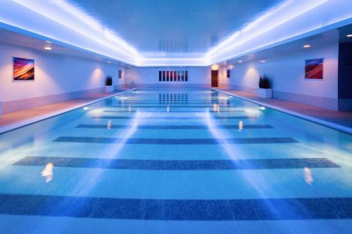 a swimming pool in a hotel with lights on at Mercure Sheffield St Paul's Hotel & Spa in Sheffield