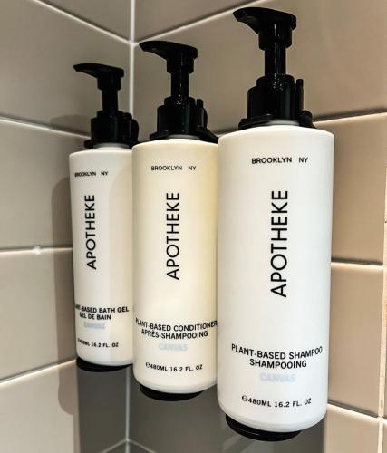 a group of three shampoo bottles sitting on a shelf at Crowne Plaza Manchester City Centre by IHG in Manchester