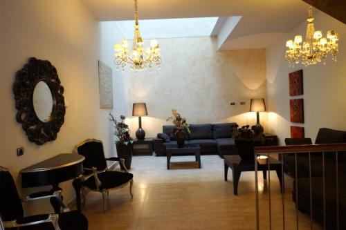 a living room with a blue couch and chairs at Don Agustin in San Luis de Sabinillas