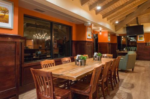 a dining room with a wooden table and chairs at Toftrees Golf Resort in State College