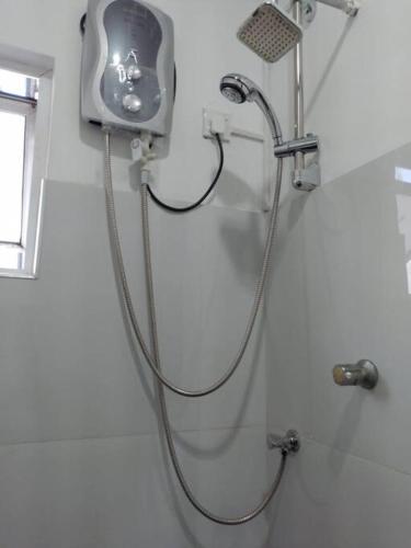 a shower with a hose attached to a wall at Dil Apartments - Mount Lavinia in Mount Lavinia