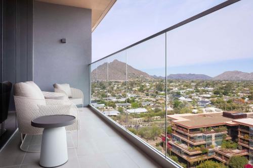 a room with a view of a city at Caesars Republic Scottsdale, a Hilton Hotel in Scottsdale