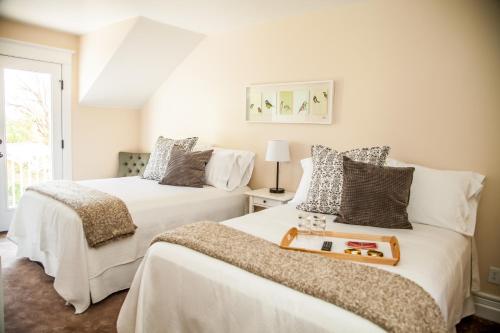 two beds in a room with white walls at Grand Circle Lodge in Kanab