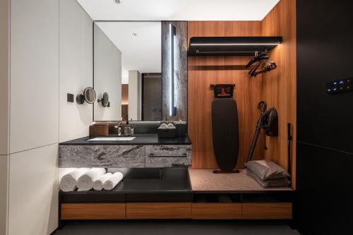 a small kitchen with a sink and a mirror at Intercity Shanghai Lujiazui Center near Pudong South Road Subway Station- Free Minibar for First Night in Shanghai