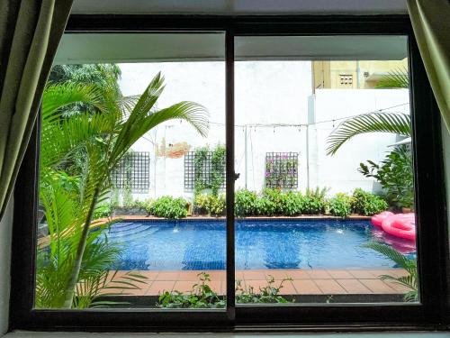 a window with a view of a swimming pool at Birdcage Boutique in Phnom Penh