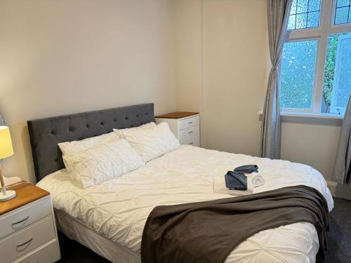 a bedroom with a bed with a hat on it at 298 Home in Christchurch