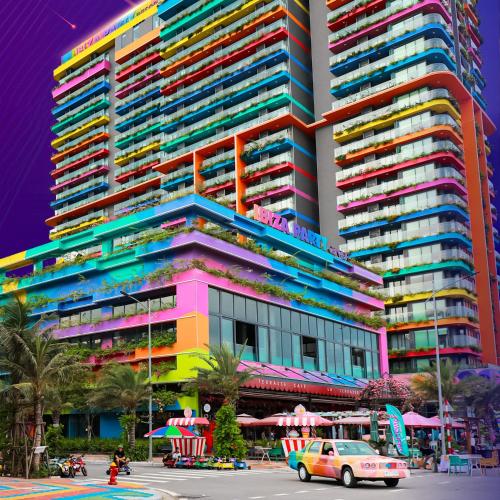 a large colorful building with a car in front of it at FLAMING0 Ibiza Hải Tiến Resort in Thanh Hóa