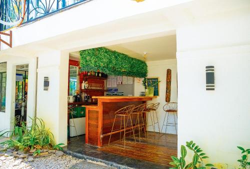 a kitchen with a bar in a house at Ciudad Caliente by The Lavana in Talisay