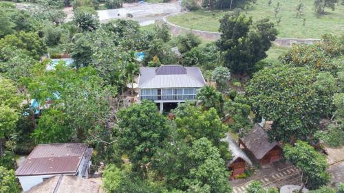 an aerial view of a house surrounded by trees at Ciudad Caliente by The Lavana in Talisay