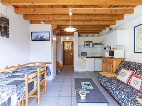 a kitchen and a living room with a bed and a couch at Appartement T4 7 pers, parking, proche stations ski - FR-1-402-145 in Luz-Saint-Sauveur