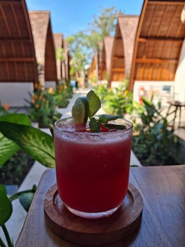 a drink is sitting on a wooden table at Abian Klumpu Villa & Spa Sanur Bali in Sanur