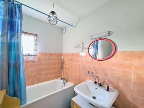 a bathroom with a sink and a tub and a mirror at Appartement 6 pers, cœur de station, proche pistes et commerces - FR-1-416-226 in La Toussuire