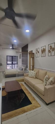 a living room with a couch and a table at HABITUS Elmina Denai Alam in Shah Alam