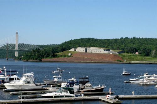 a bunch of boats docked in a harbor with a bridge at Bucksport Inn in Bucksport