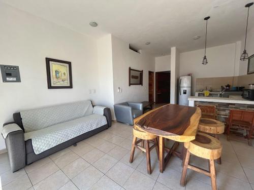 a living room with a couch and a table at Apartment 2 Maleconcito del Sol Barra de Navidad in Barra de Navidad