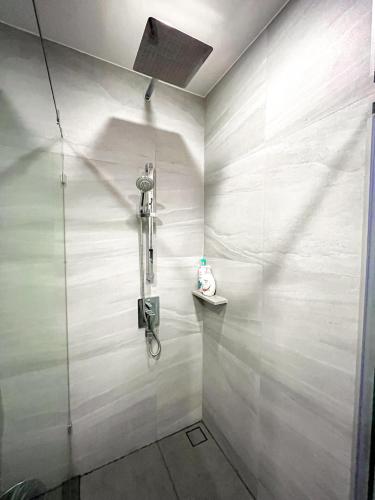 a shower with a glass door in a bathroom at The Edge central pattaya in Pattaya Central