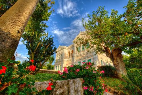 a large white house with flowers in front of it at Villa Irlanda Grand Hotel in Gaeta