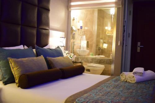 a bedroom with a large bed and a bathroom at Taksim Line Hotel in Istanbul