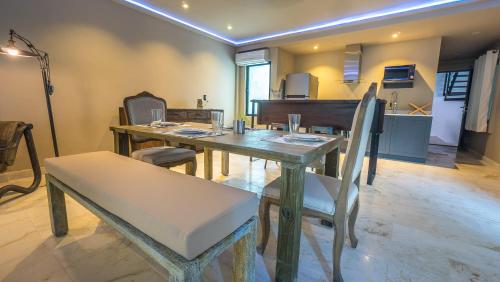 a dining room with a table and a piano at Lotus Midtown Apartments by BVR in Playa del Carmen
