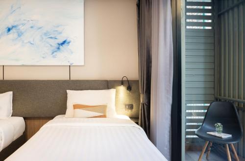 Ένα ή περισσότερα κρεβάτια σε δωμάτιο στο SOVA Hotel Bangkok