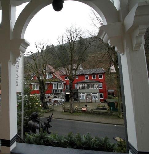 a view from an archway of a building with a statue at Hotel Rathaus in Wildemann