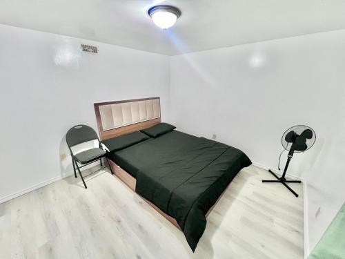 a bedroom with a bed and a chair in it at Private Room Near Airport D7 in Brampton