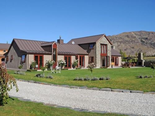 a large house with a yard with a house at Three Thirty B & B in Queenstown