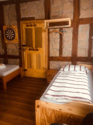 a bedroom with a large bed and a door at Wohnung 40 Quadratmeter in Arnstein