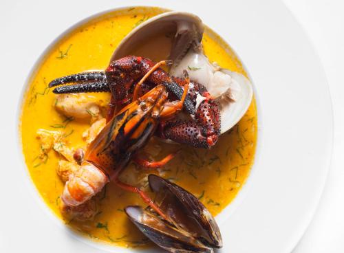 a plate of food with seafood and a spoon at Casa Grande Hotel in La Paz