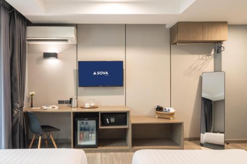 Ένα ή περισσότερα κρεβάτια σε δωμάτιο στο SOVA Hotel Bangkok