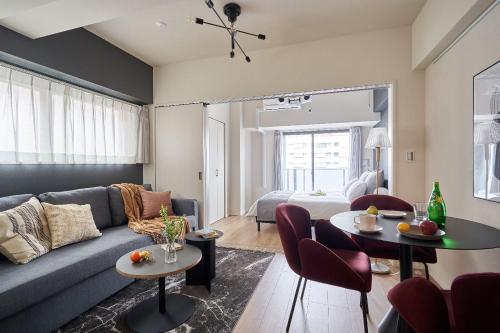 a living room with a couch and a table at Altovilla Toranomon in Tokyo
