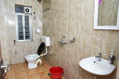 a bathroom with a toilet and a sink at City Central Hostel in Kolkata