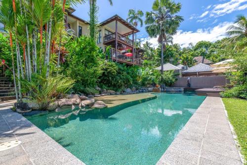 an image of a swimming pool in front of a house at The Point Villa 10 in Port Douglas