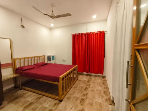 a bedroom with a bed and a red curtain at Palmquist Villa in Neral