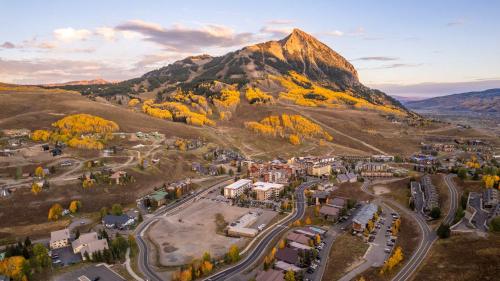 an aerial view of a town in front of a mountain at 1bd 272 Perfect Location with Pool in Crested Butte