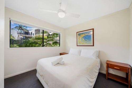 a bedroom with a white bed and a window at Unit 10 Marcoola Beach Resort in Marcoola