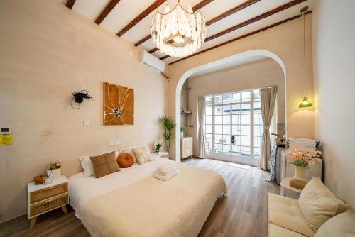 a large bedroom with a large bed and a chandelier at Tonight Homestay South Shanxi Road Shanghai in Shanghai
