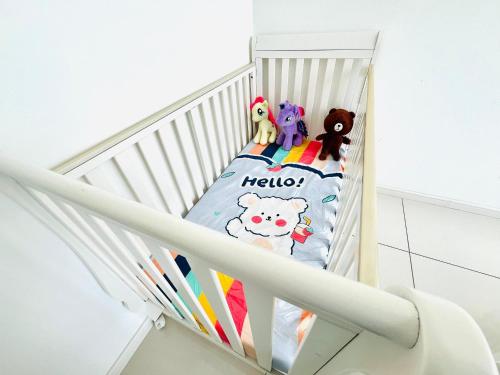 a white crib with many stuffed animals on it at ELYSIA-Near Gleaneagles & Legoland-2RB WarmQ Suite Max7pax-WaterDispenser in Nusajaya