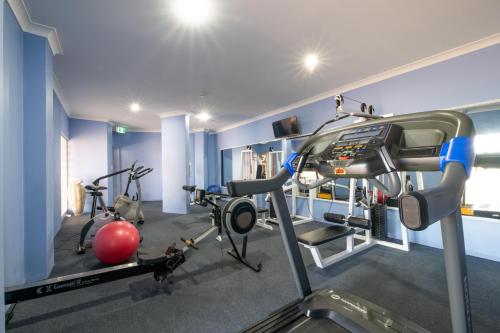 a gym with two exercise bikes and a simulator at Martinique Whitsunday Resort in Airlie Beach