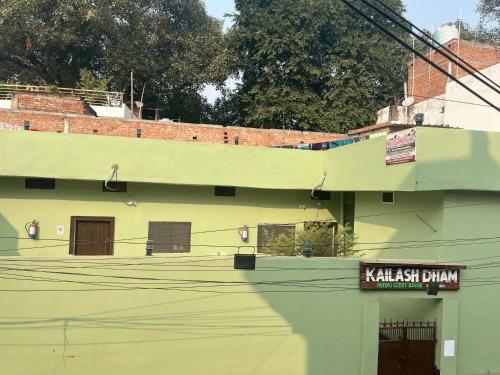 a green building with a sign on the side of it at Kailash Dham in Varanasi