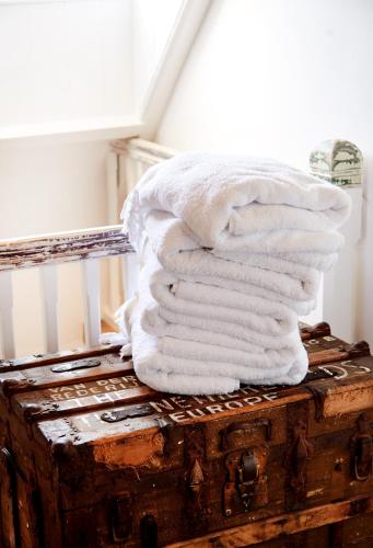 a pile of towels sitting on top of a suitcase at Hotel Station Amstelveen in Amstelveen