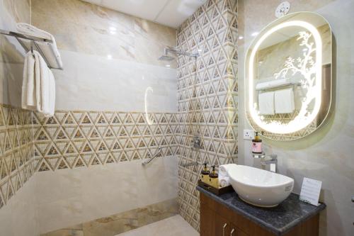 a bathroom with a sink and a mirror at Alaya Stays Lafu Woodscave Room with Attic & Hill views in Shimla