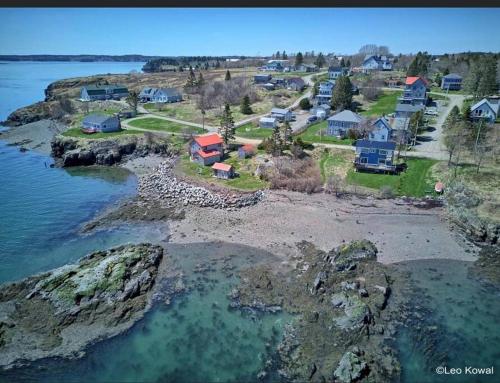 an aerial view of a village on the shore of a body of water at Colonels Quarters in Eastport