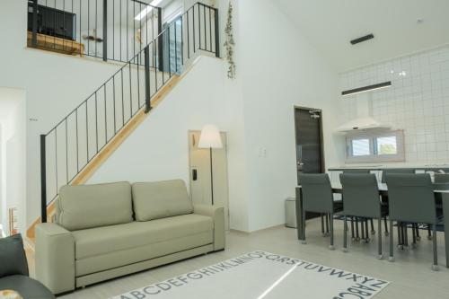 a living room with a couch and a table at The Stay Christmas Yusuam in Jeju