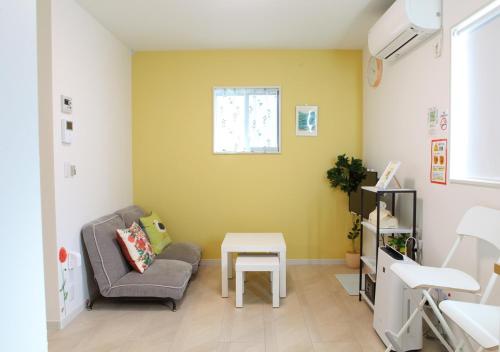a living room with a couch and a table at MARINO1 - Vacation STAY 40010v in Fukuyama